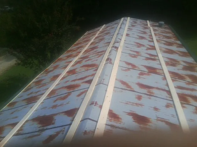 Rusted metal roof panels with new wood purlins before replacement — Storm Damage Roof Repair in Jersey by Roofing Brothers